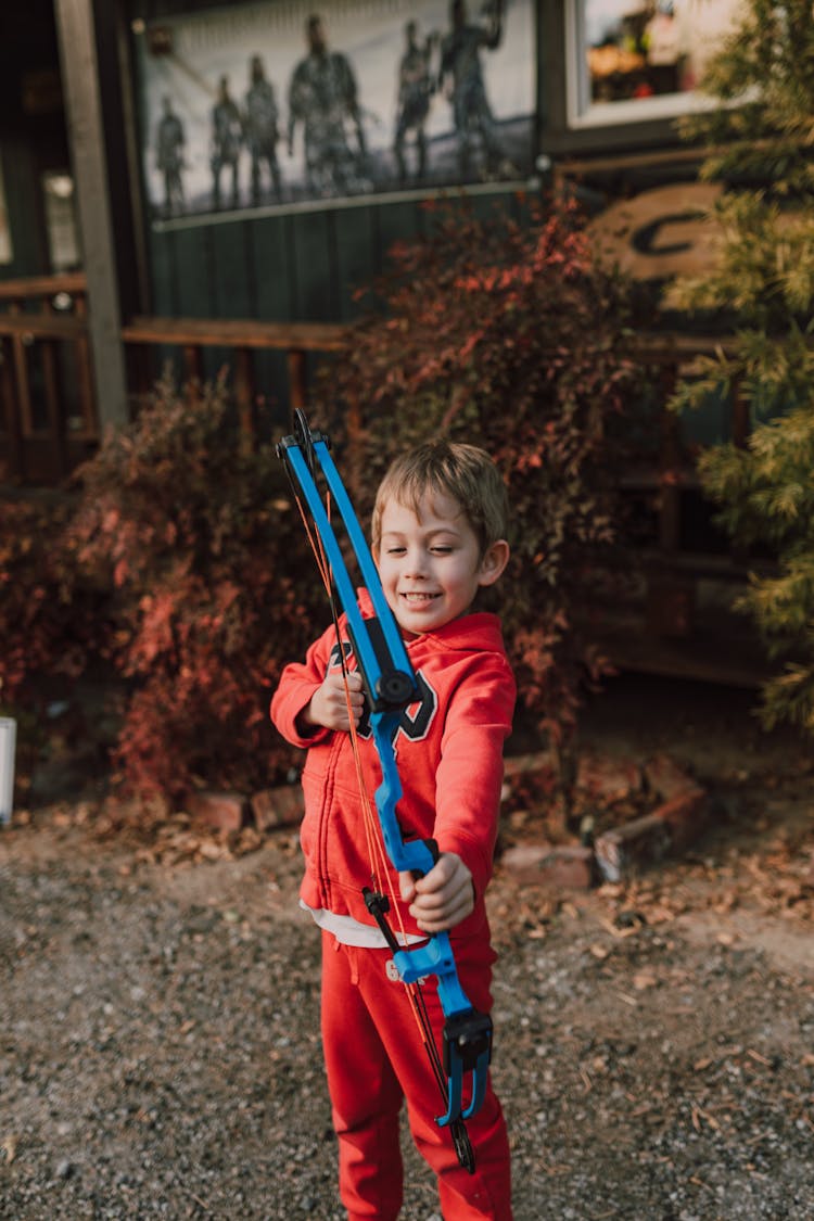 A Boy Holding An Archery Bow