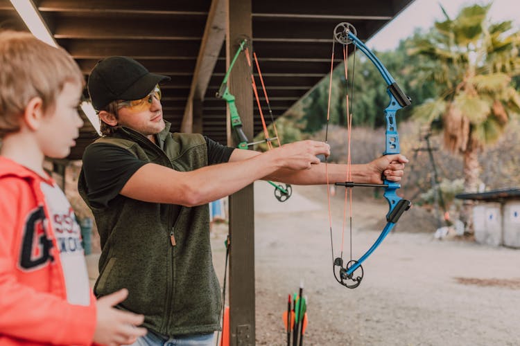 A Man Pulling The String Of A Bow