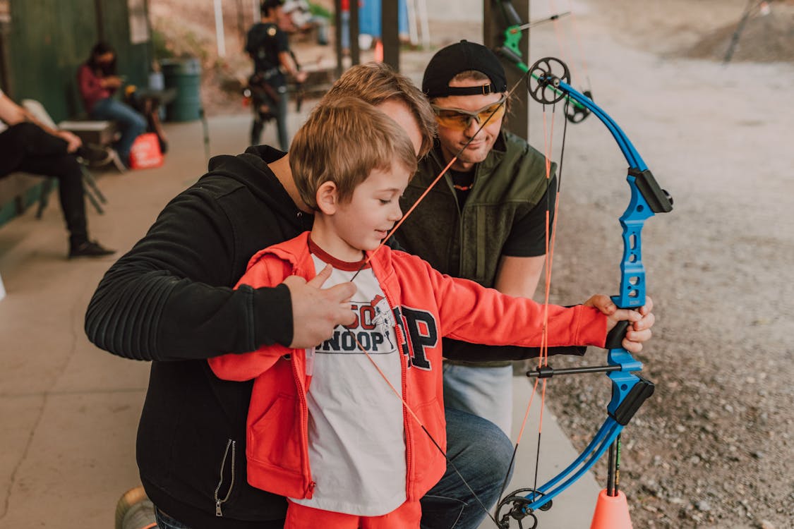 Boy in Red and White Hoodie Holding Blue Rope