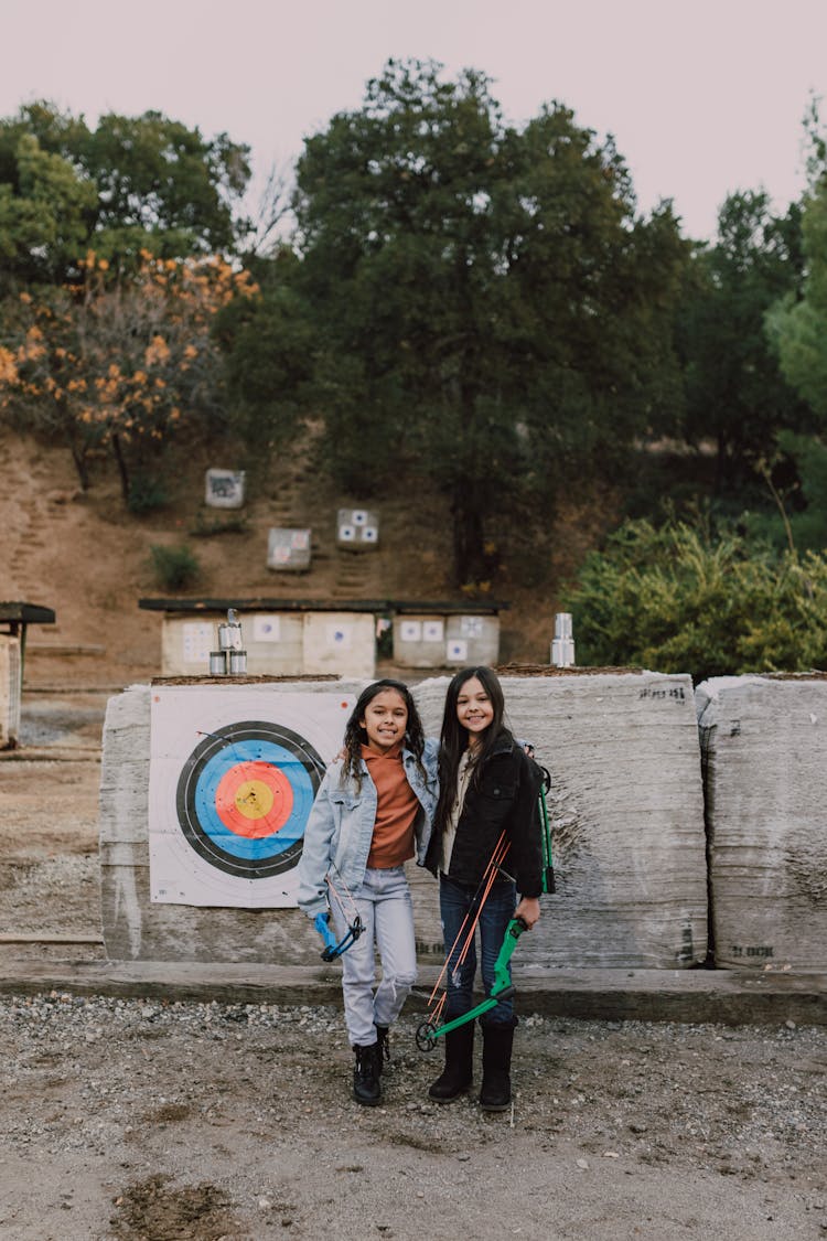 Two Girls Holding An Archery Bow