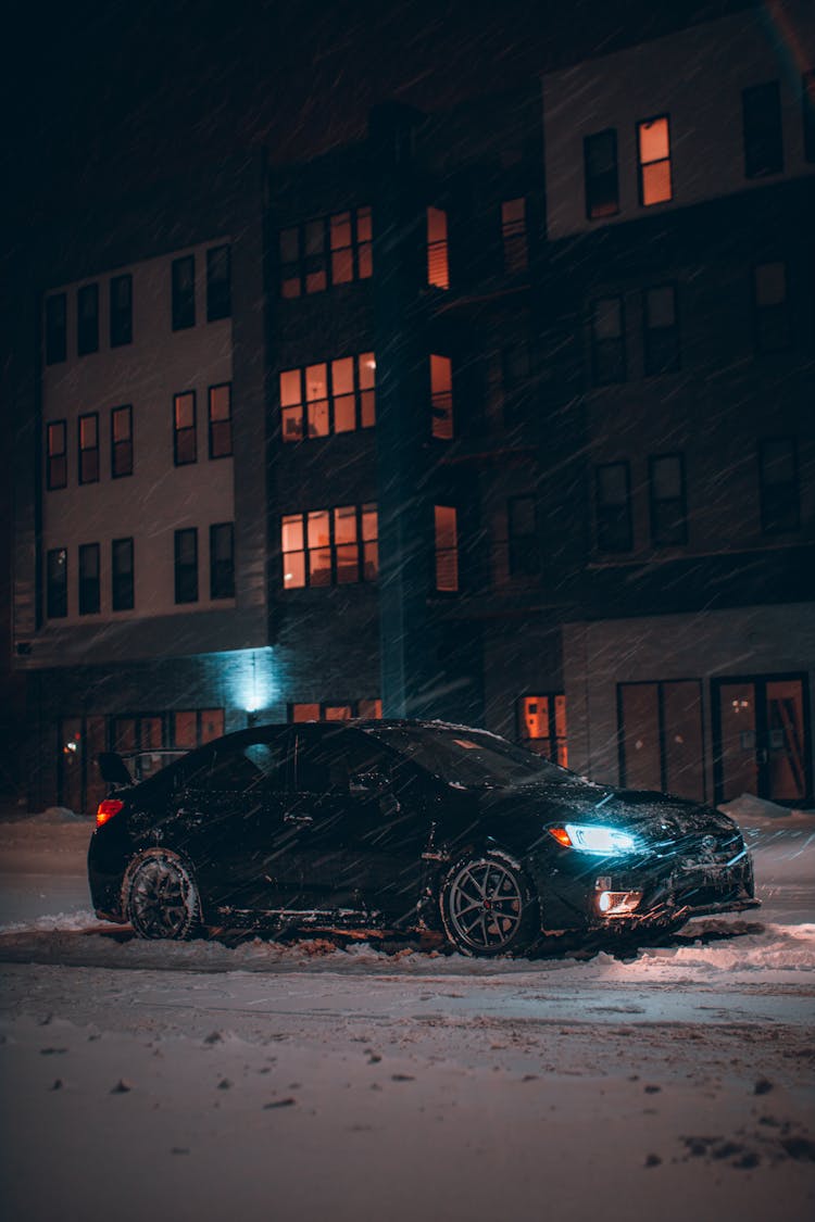 Car Driving In A Residential Area On A Winter Night