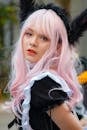 A Young Woman Wearing a Black Dress and Pink Wig