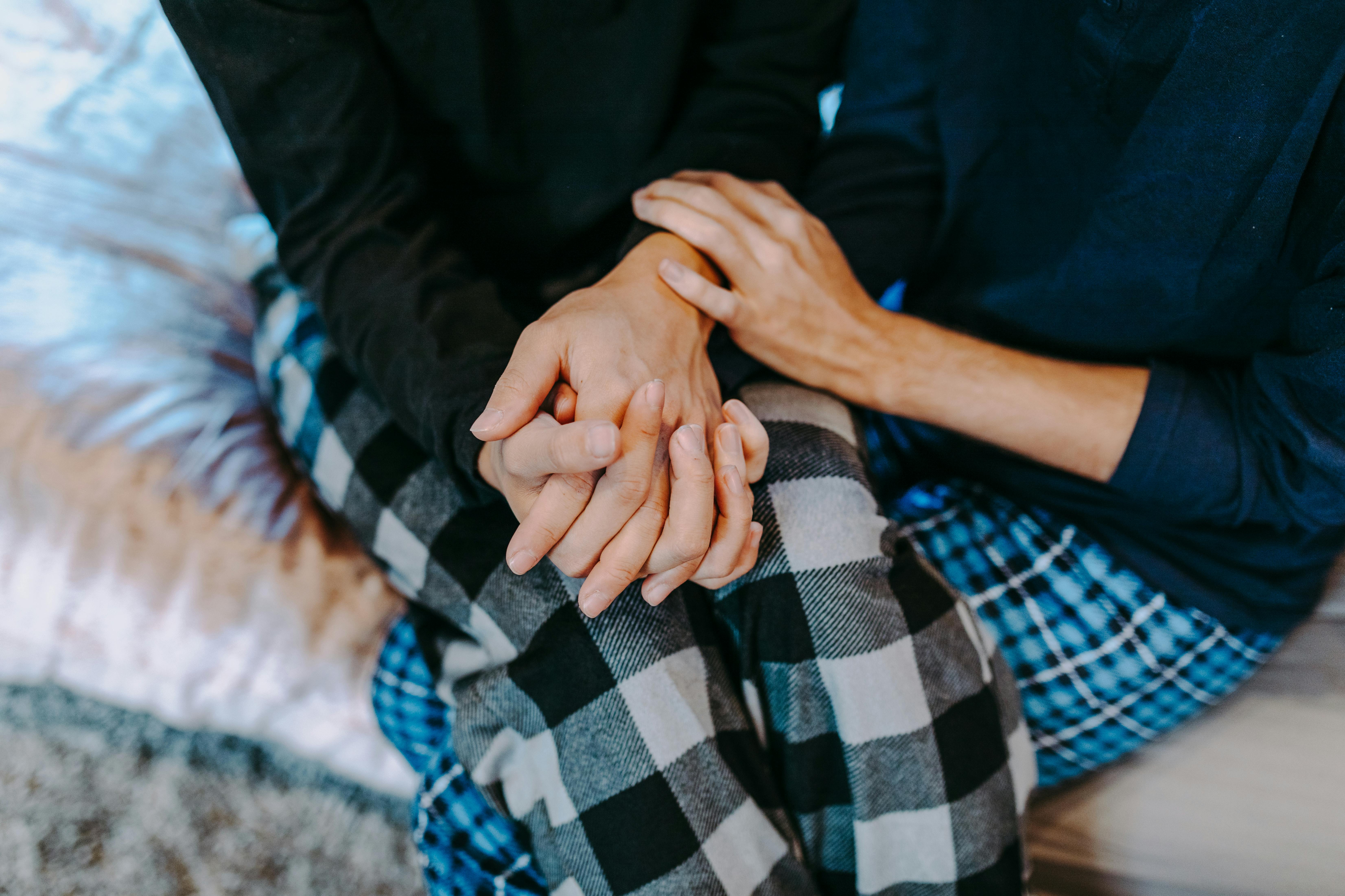 person in black shirt and blue white plaid pants