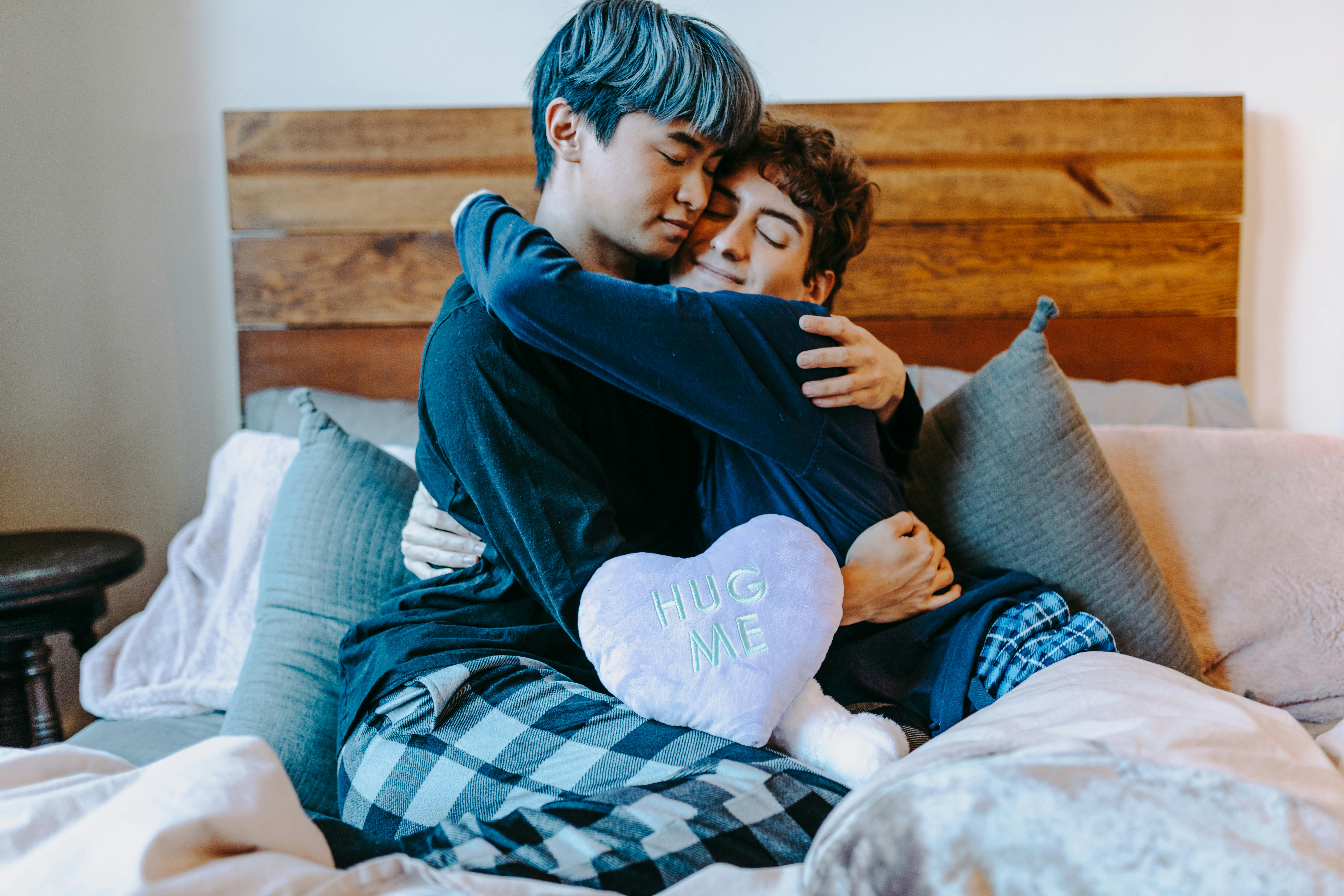 boy in purple sweater hugging girl in blue sweater