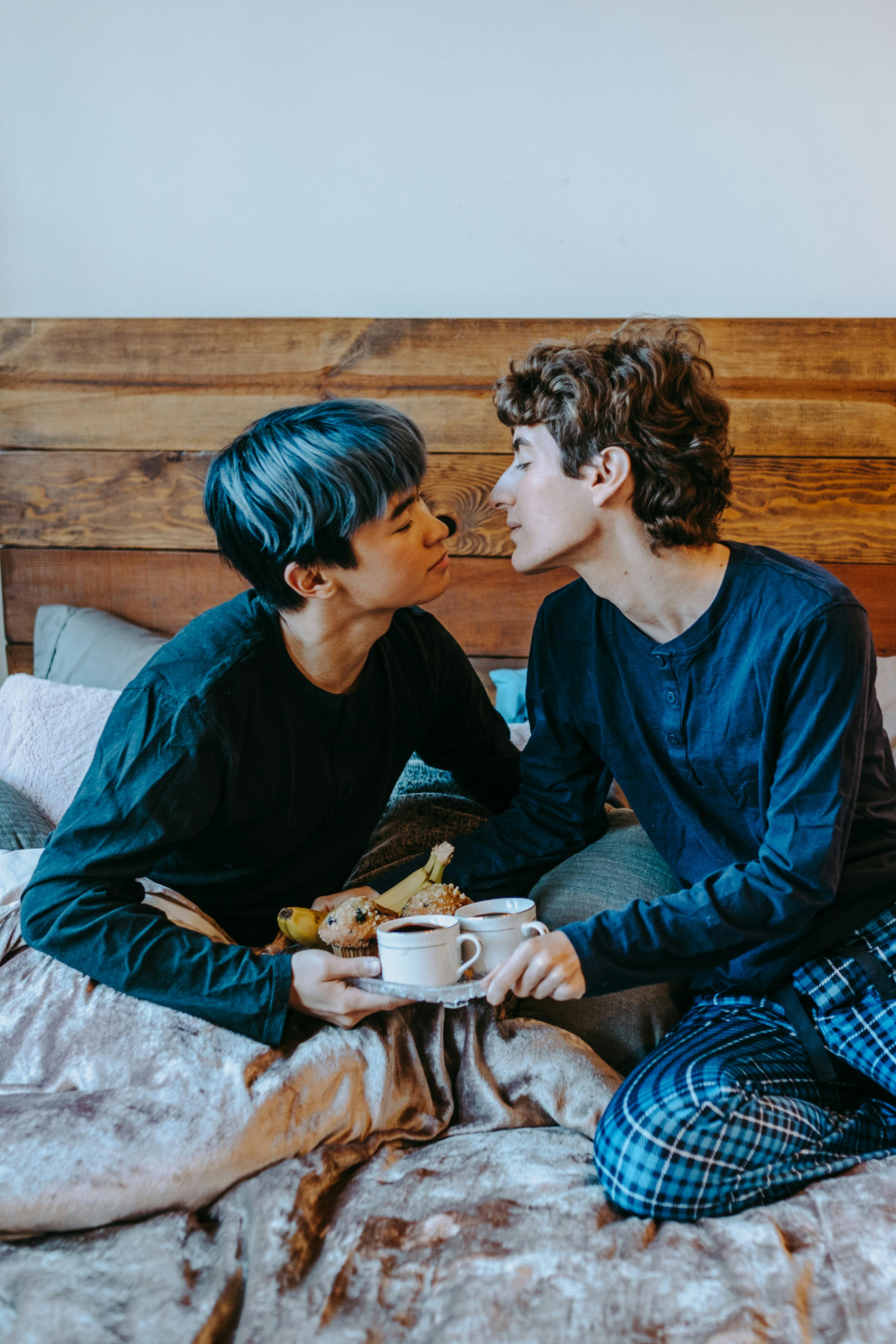 2 boys sitting on bed