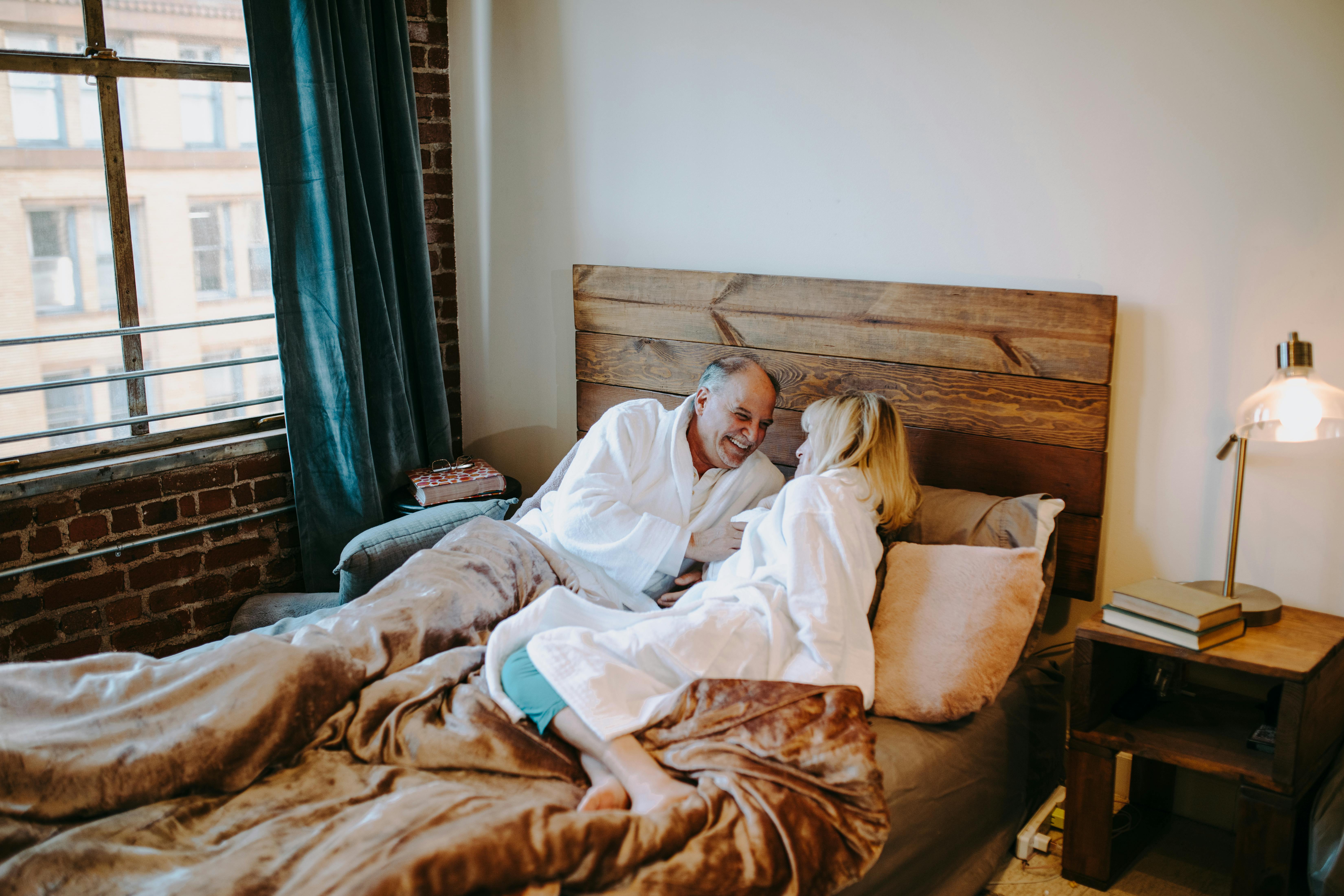 man in white dress shirt lying on bed