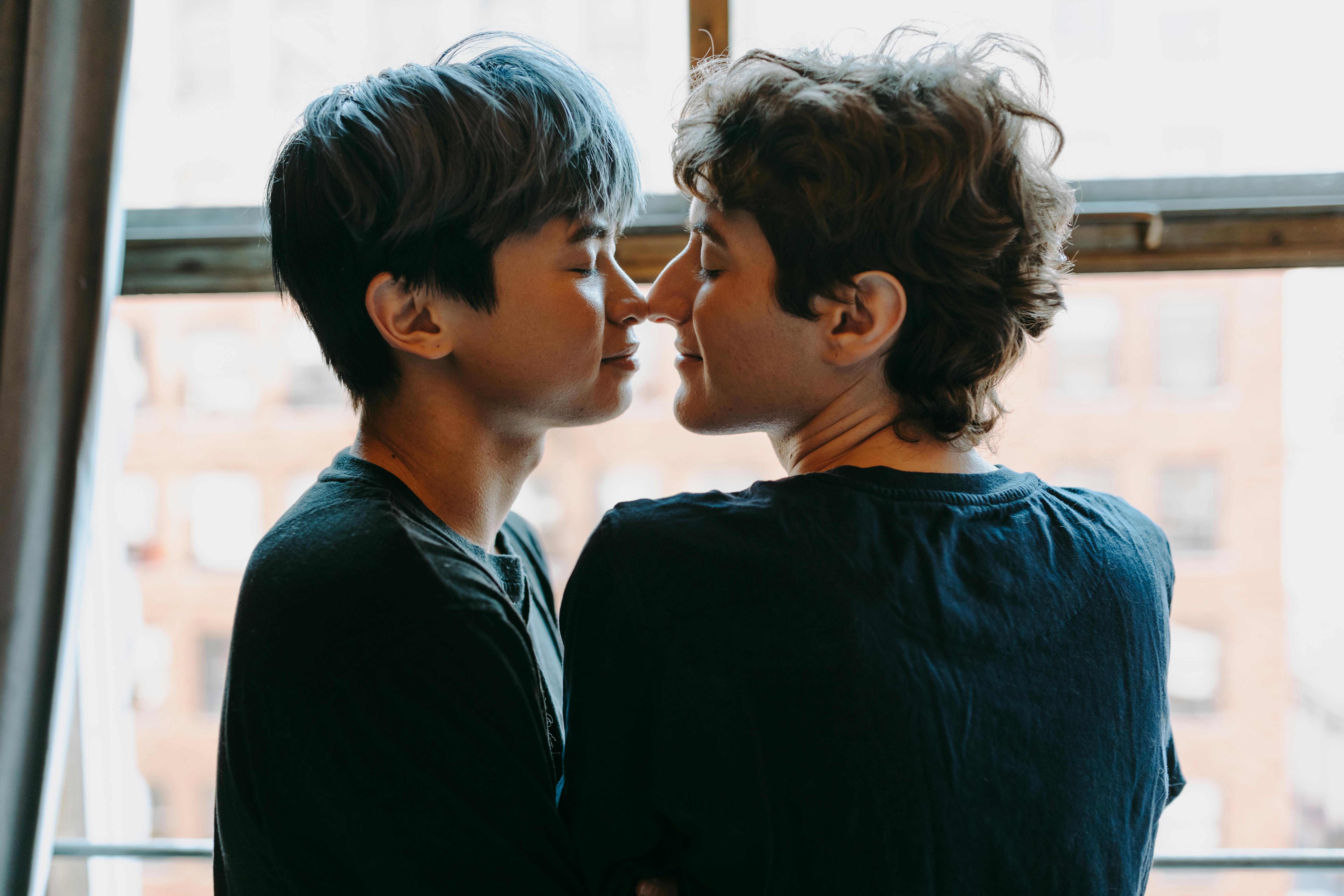 man in black shirt kissing woman in black shirt