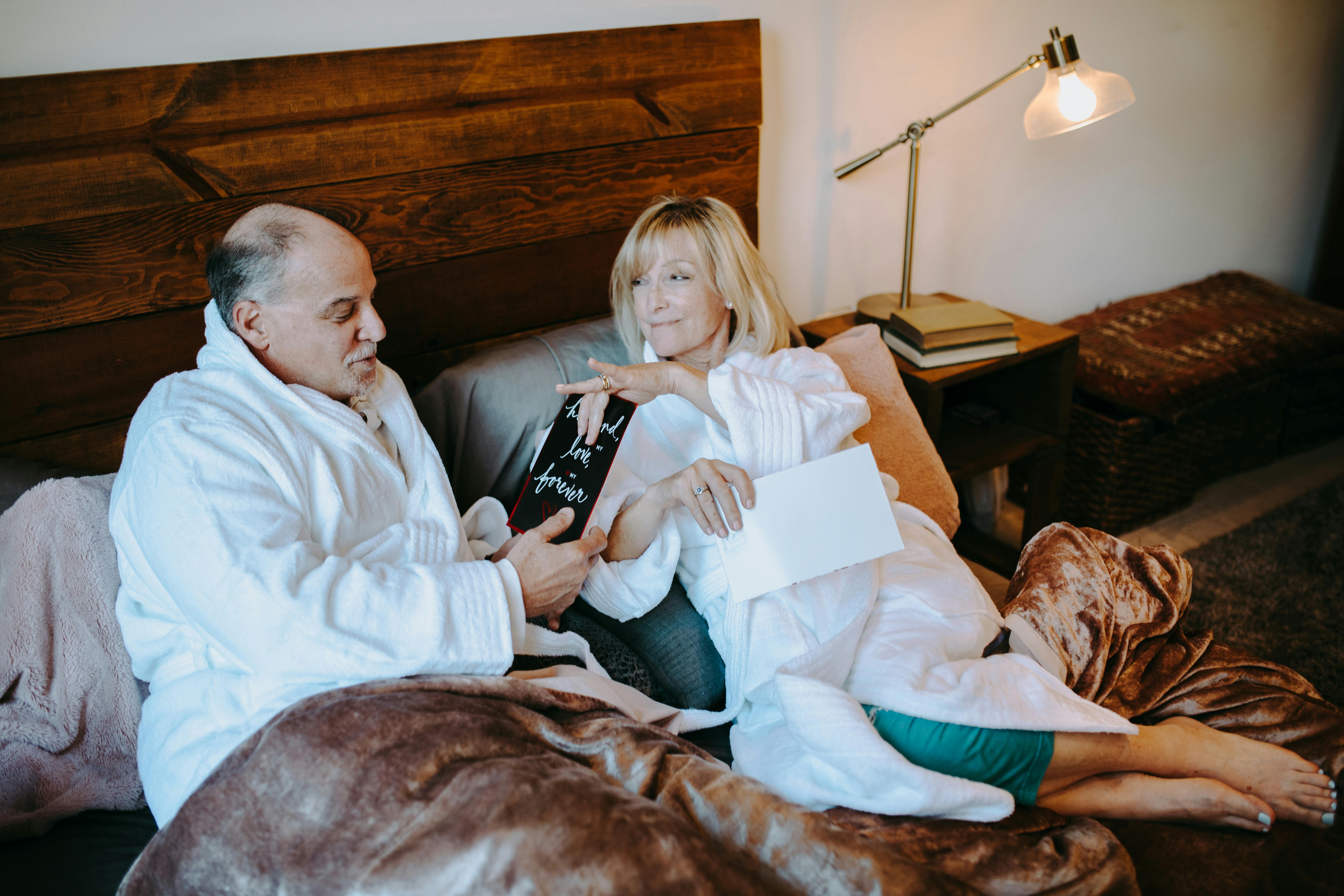 man in white dress shirt sitting beside woman in brown shirt