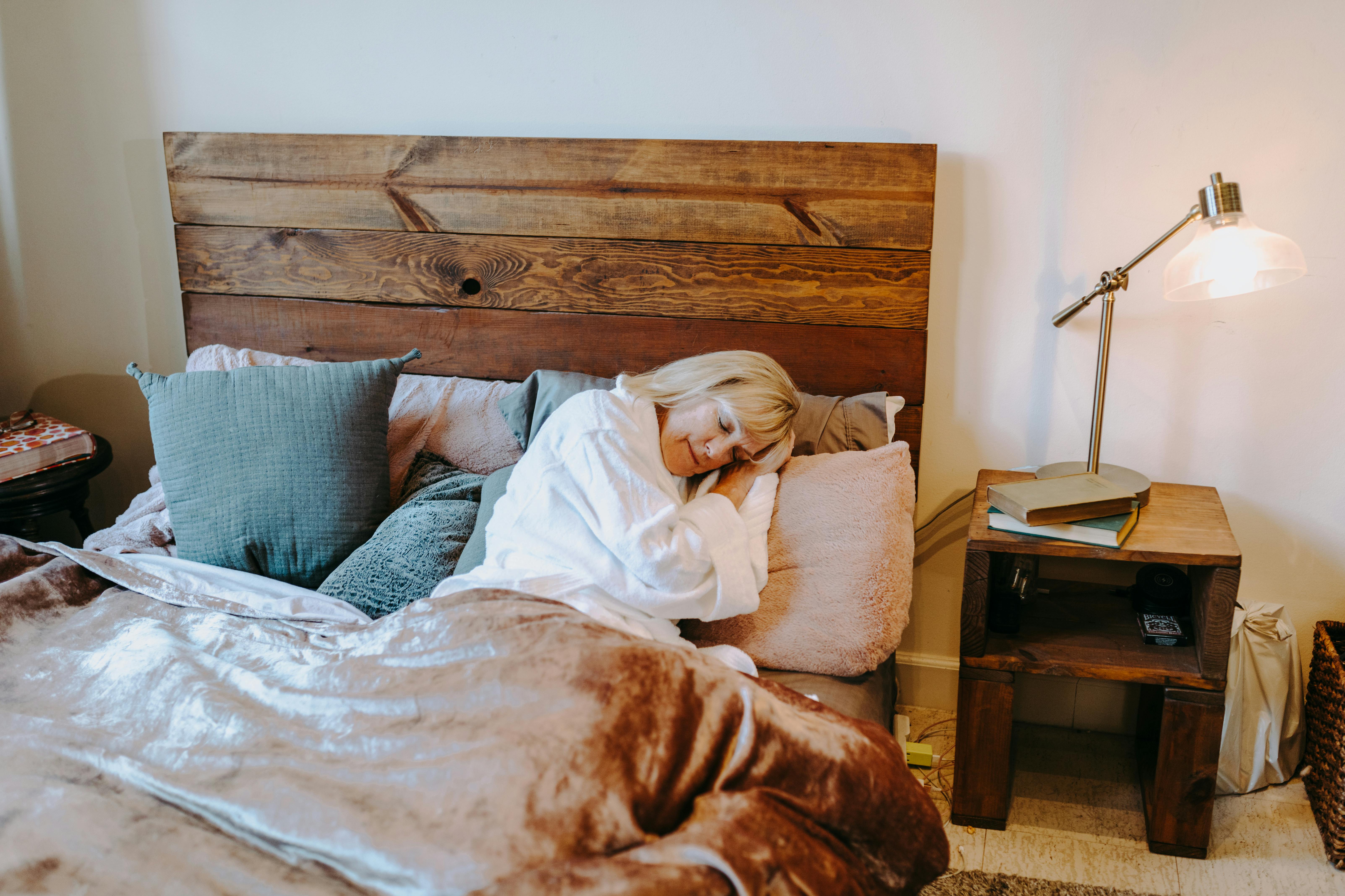 woman in white shirt lying on bed