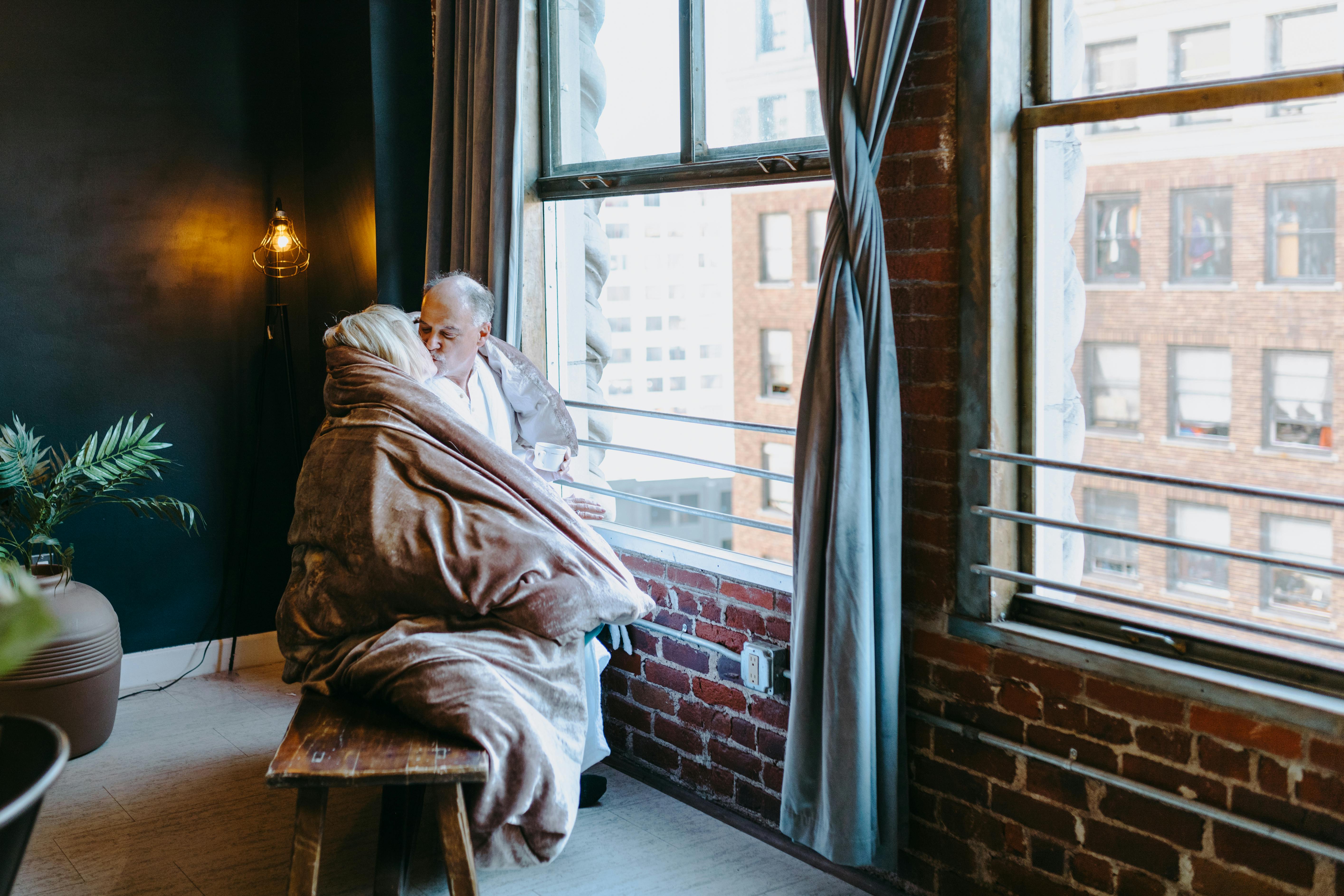 man in white robe sitting on brown wooden chair