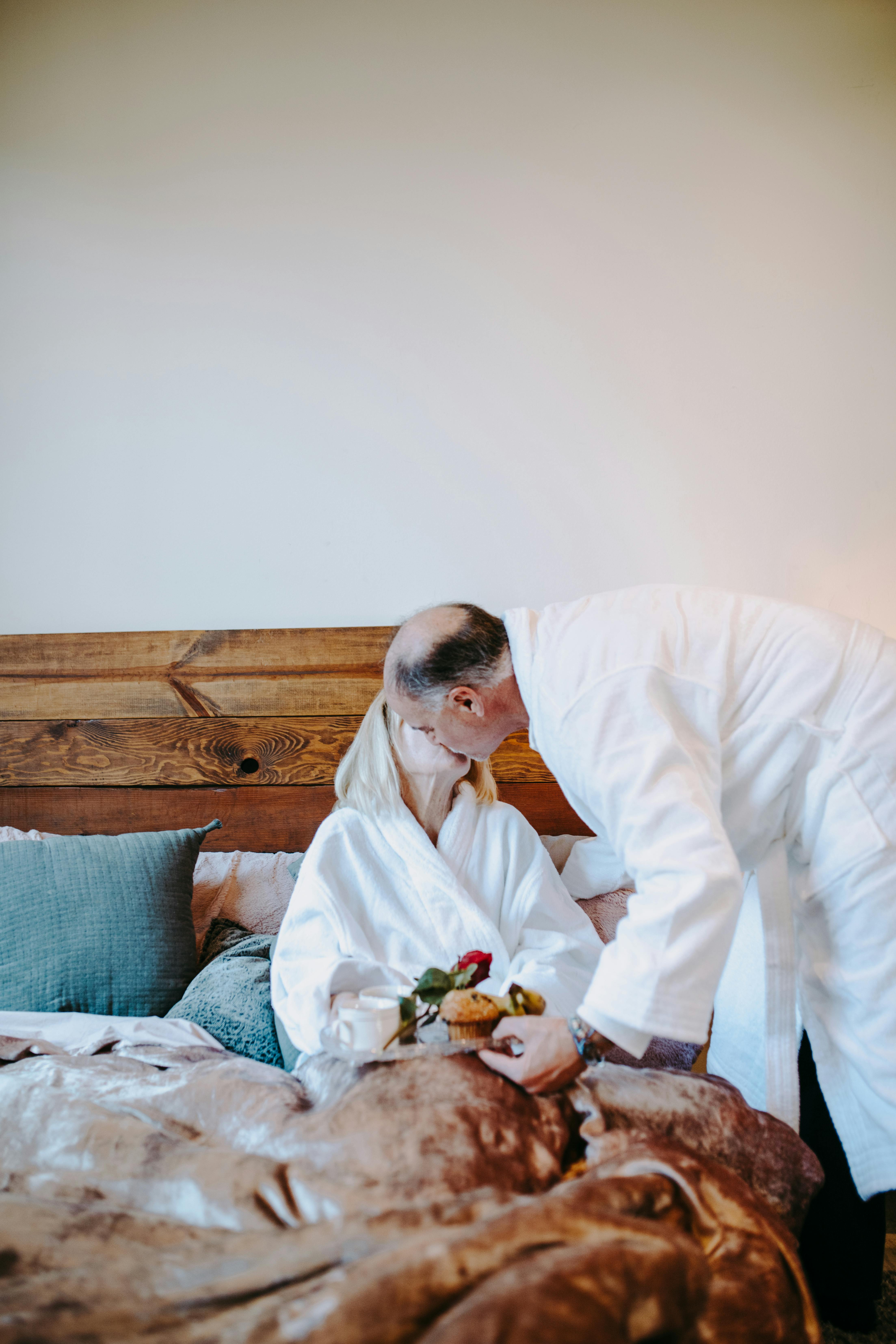 man in white thobe sitting on bed