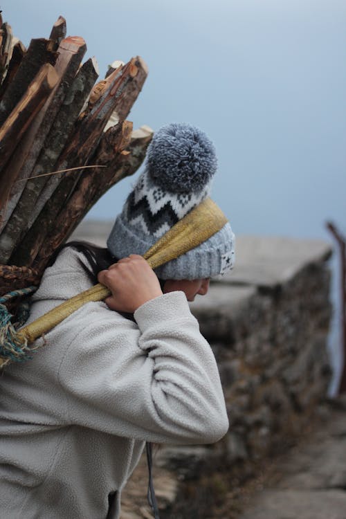 Woman Carrying a Big Bundle of Firewood 