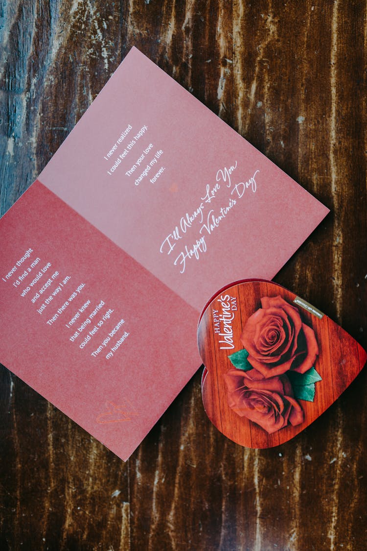 A Valentines Card And Chocolate On The Wooden Table