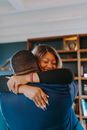 Man in Black Shirt Hugging Woman in Black Shirt