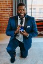 Man in Blue Suit Jacket and White Dress Shirt Holding Blue Ceramic Mug