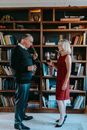 Man in Black Suit Jacket Kissing Woman in Red Dress