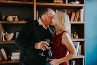 Man in Black Suit Jacket Holding Woman in Red Sleeveless Dress