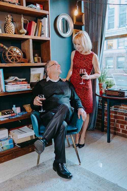 Free Photo of an Elderly Couple Looking at Each Other while Holding Glasses of Wine Stock Photo