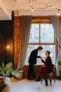 A Couple by the Glass Window Looking at Each Other