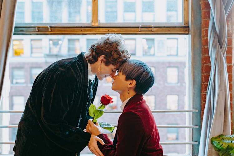 Photo Of A Couple Head To Head Near A Window