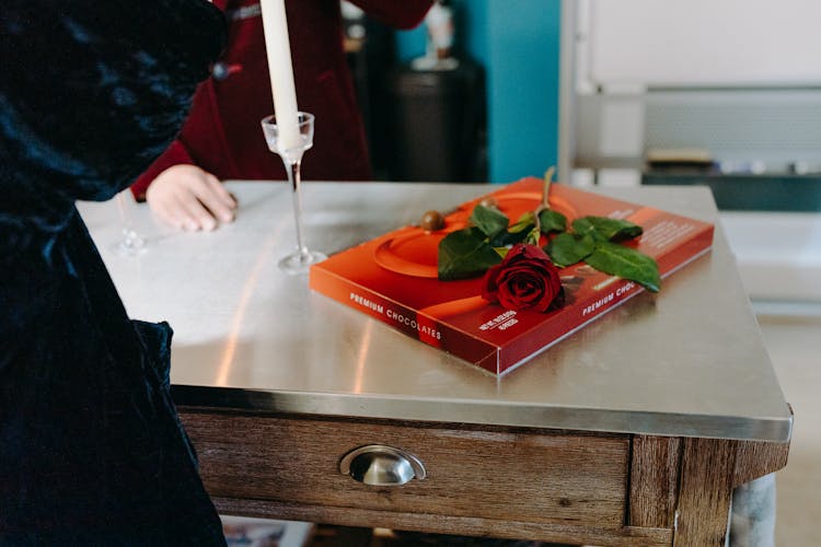 Photo Of A Rose On A Box Of Chocolates