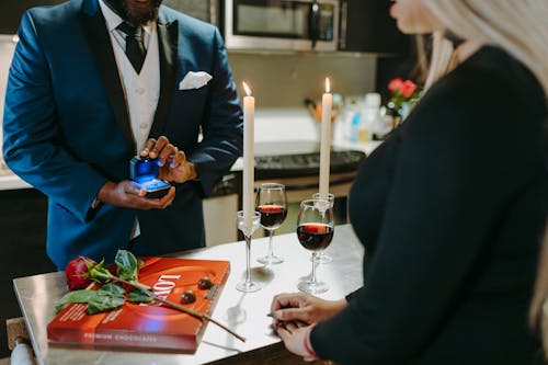 Free A Man in Blue Suit Holding a Ring Box with Engagement Ring Stock Photo