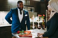 Man in Blue Suit Jacket Holding Red and Green Bouquet