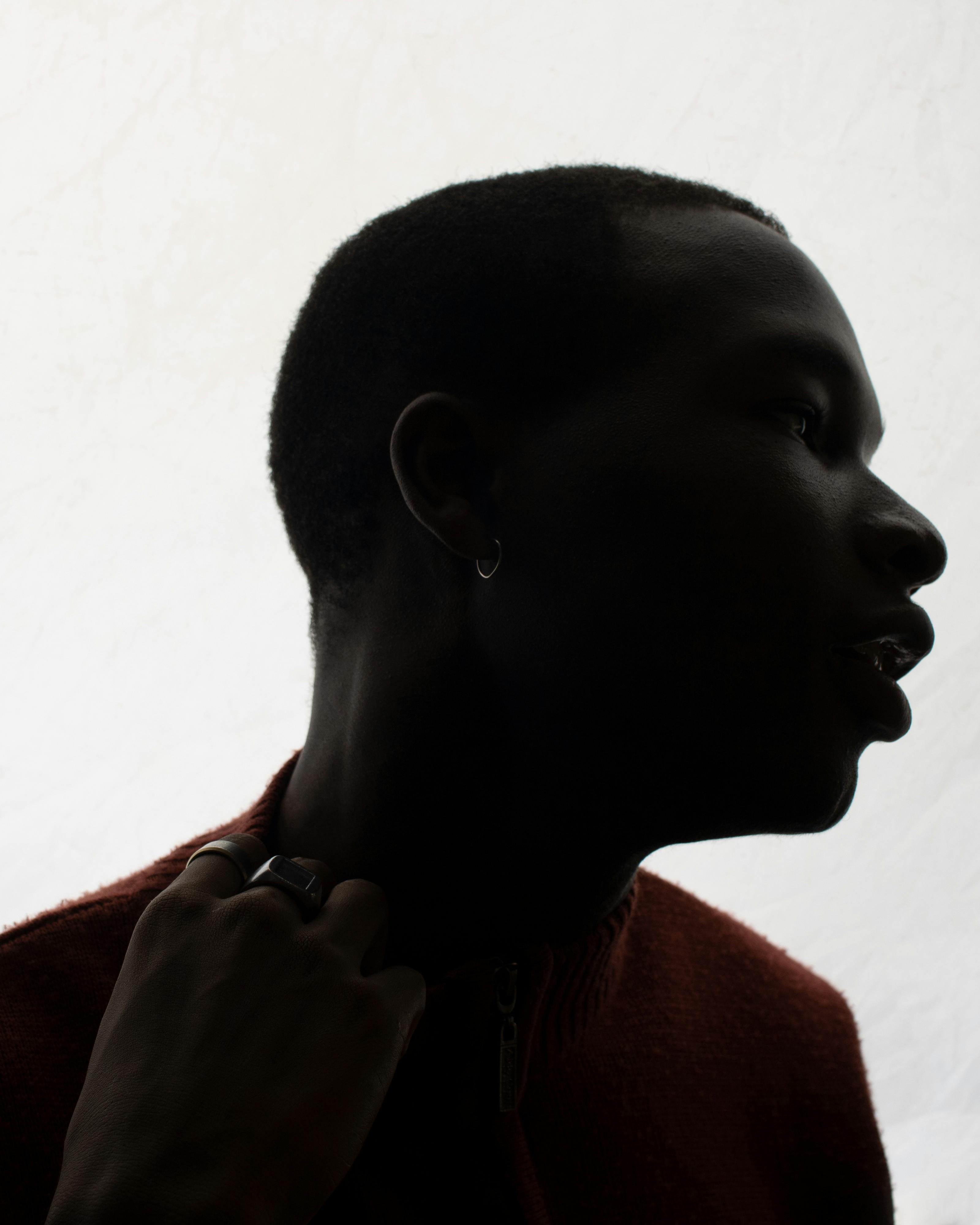 Artistic silhouette portrait of a person with soft lighting creating a dramatic effect.