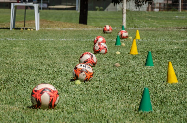 Photograph Of Soccer Balls Near Training Cones