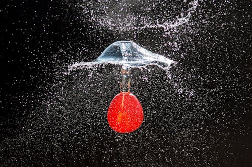 Free A Red Object Sinking in Water Stock Photo