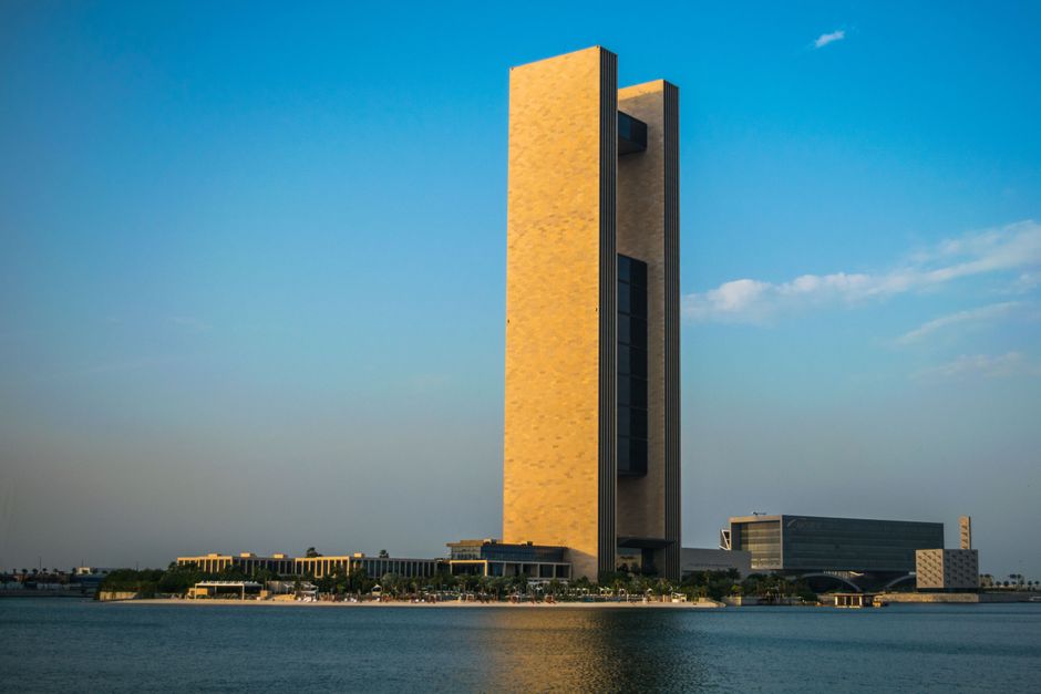 Stunning view of an iconic skyscraper on the Bahrain waterfront under clear blue skies.