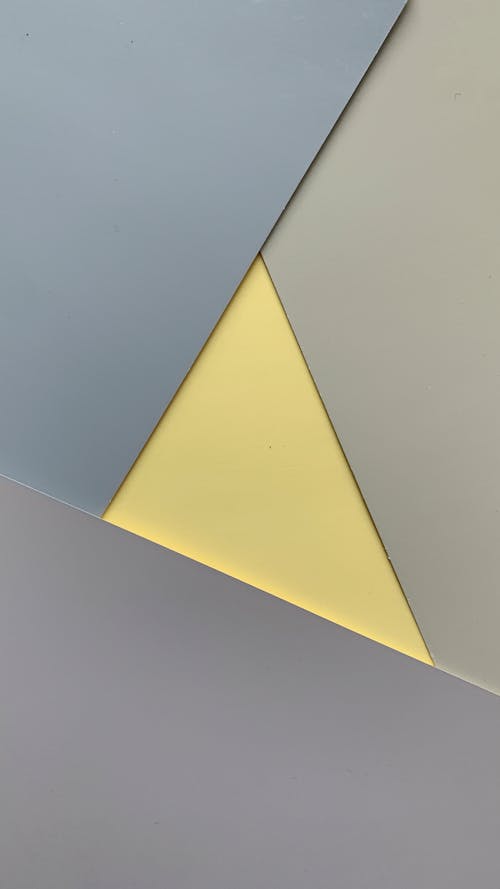 Free Yellow Triangle on White Surface Stock Photo
