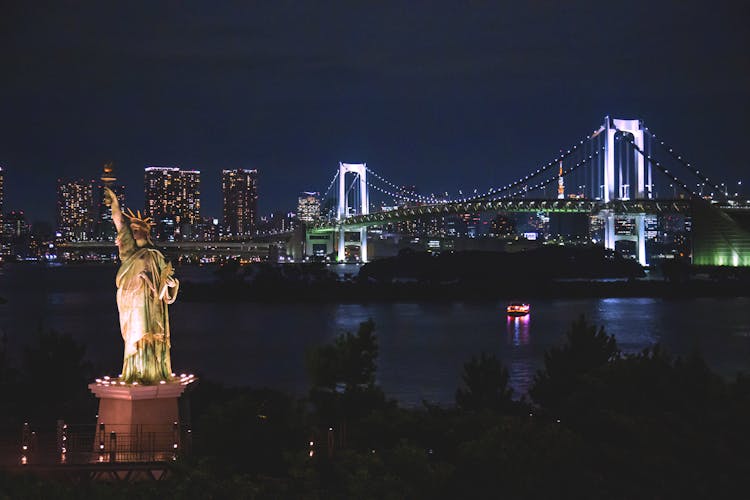 The Lighted Rainbow Bridge In Tokyo Bay At Night