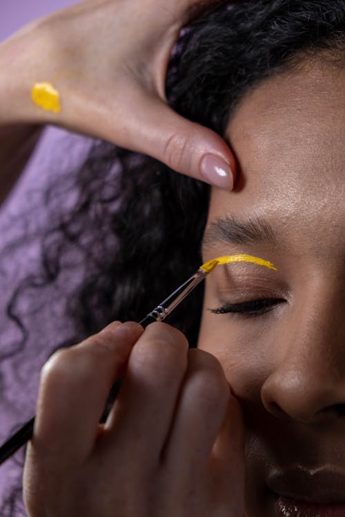 Free A Woman Eye Lid Painted with Yellow Stock Photo