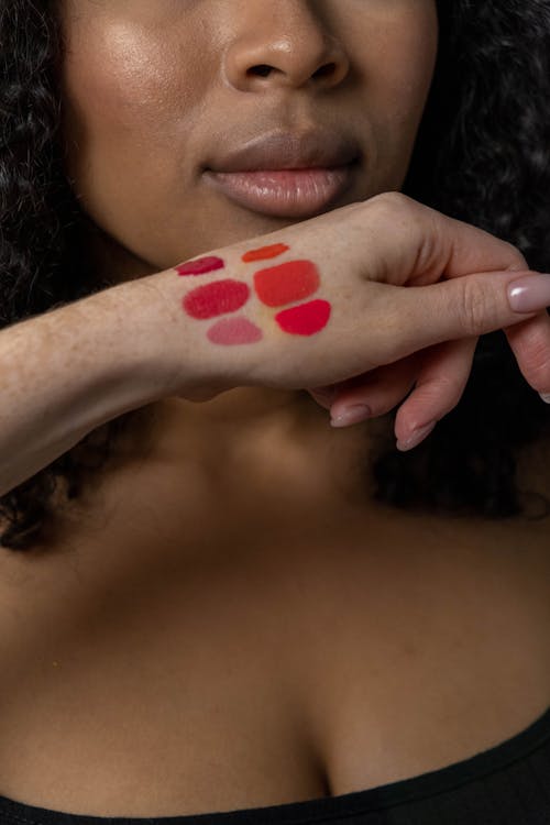 Hand of a Woman With Lipstick Shades
