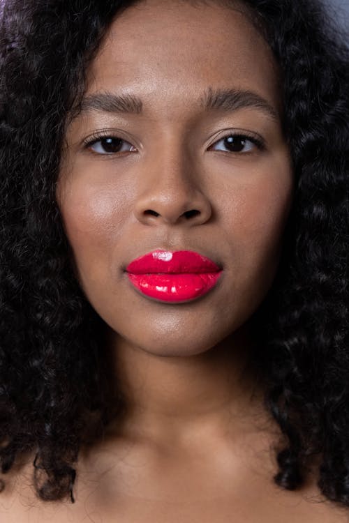 A woman Wearing a Glossy Pink Lipstick