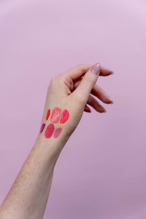 Hand of a Person With Lipstick Shades