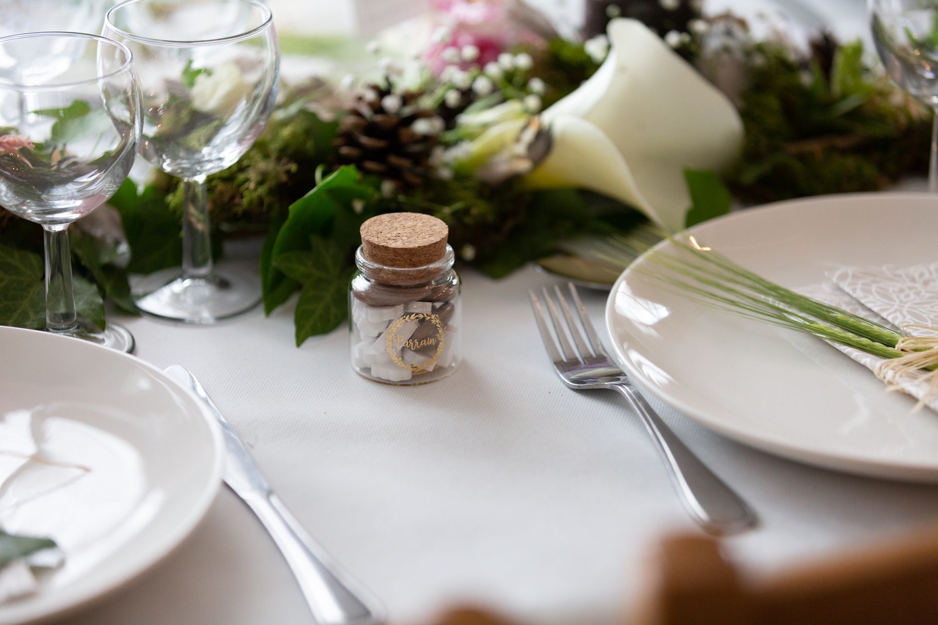 Elegantly arranged table setting with cutlery, glassware, and floral decor for dining.