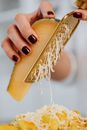 A Person Grating a Cheese