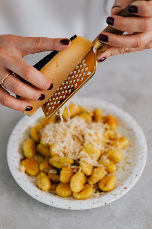 Free Close-up of creamy gnocchi topped with freshly grated Parmesan cheese. Stock Photo