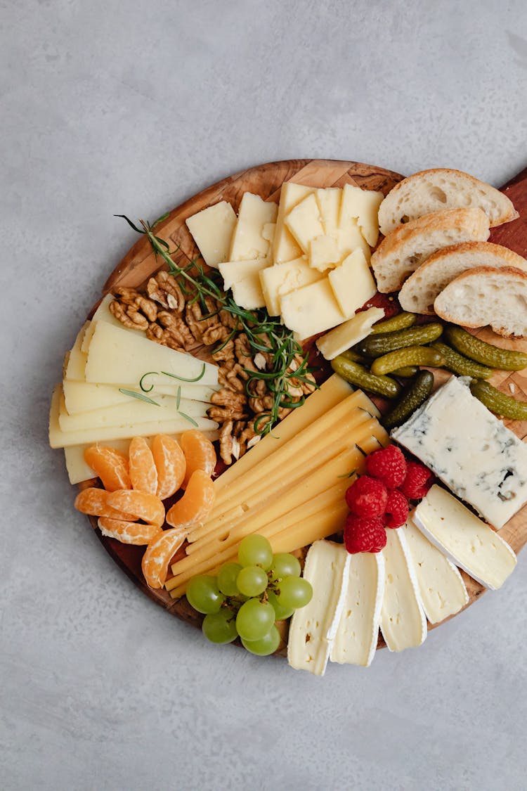 A Charcuterie Board With Cheese And Fruits