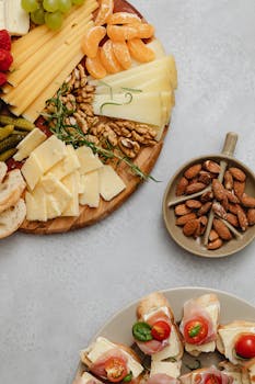 A gourmet selection of cheeses, fruits, and nuts on a charcuterie platter.