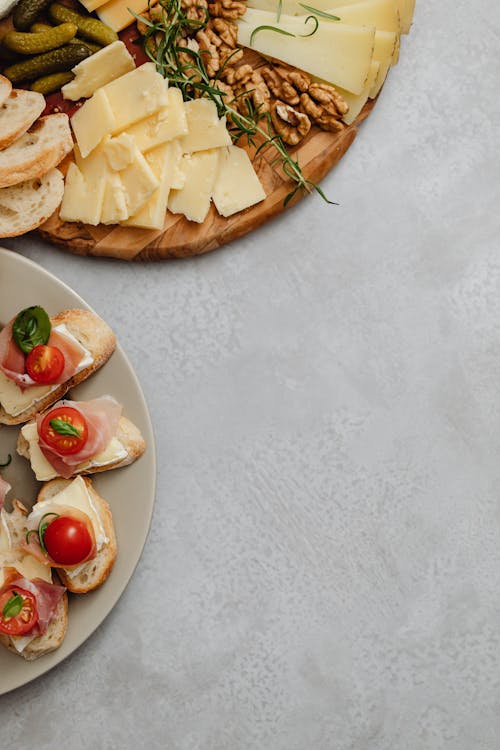 Free An Assorted Food on a Charcuterie Board and a Ceramic Plate Stock Photo
