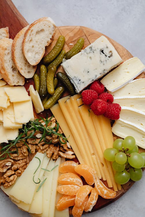 Sliced Fruits and Cheese on Wooden Board