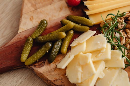 A delicious charcuterie board featuring cheese slices, pickles, and nuts, perfect for gourmet appetizers.