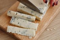Sliced Cheese on Brown Wooden Chopping Board