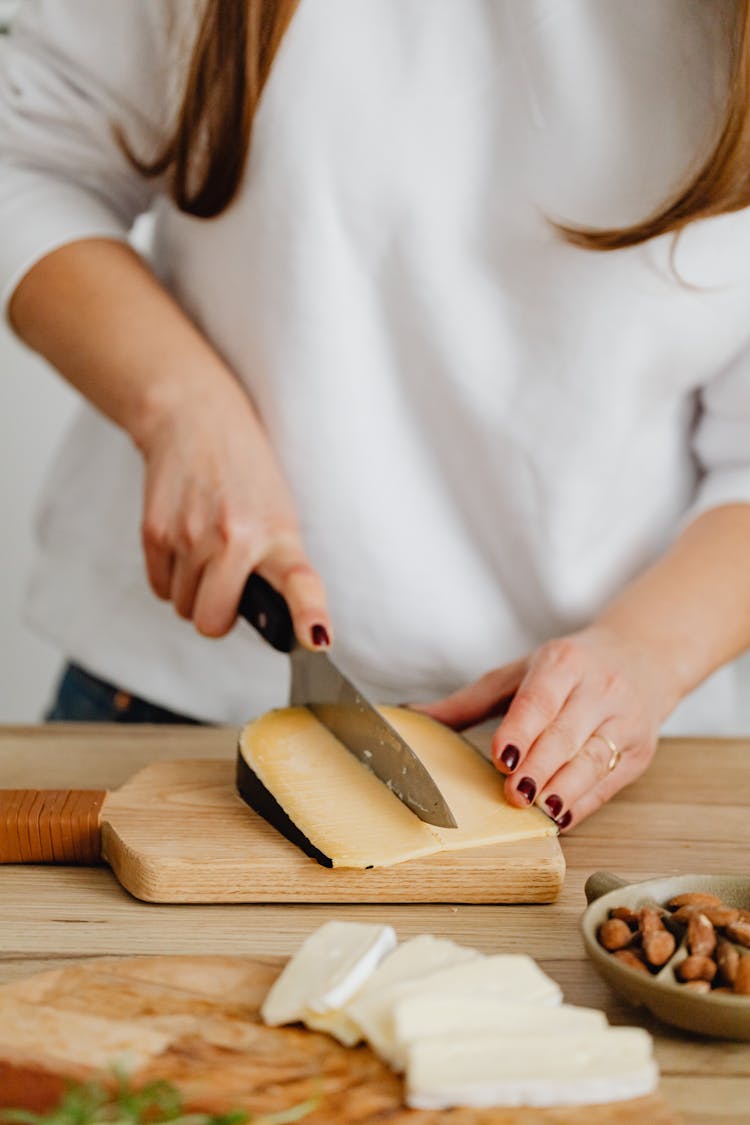 Photo Of A Person Slicing Cheese