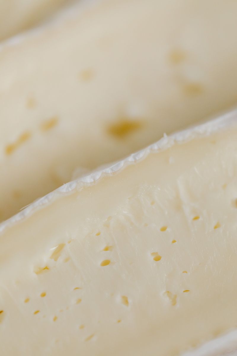 Delicious close-up of creamy brie cheese showcasing its rich texture and rind.