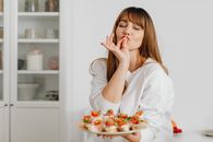 A Woman Holding a Plater of Food