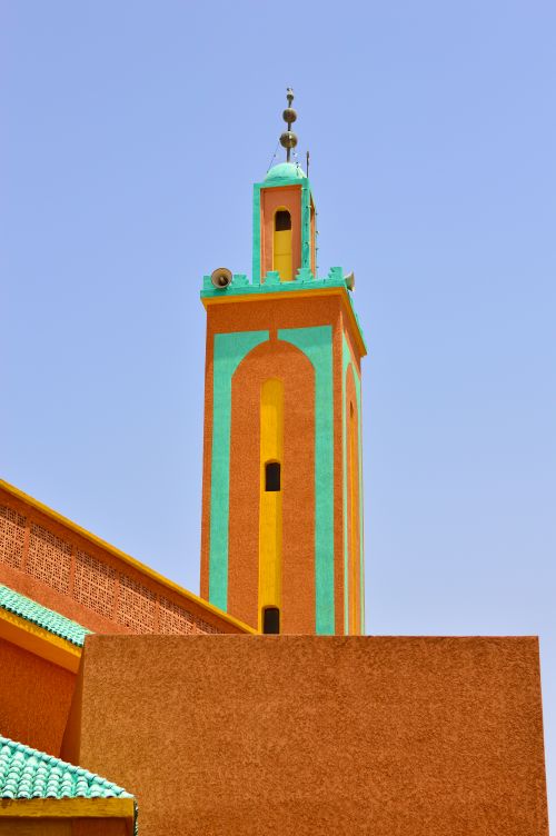 Free A vibrant tall minaret against a clear blue sky in Tiznit, Morocco, showcasing Moroccan architecture. Stock Photo